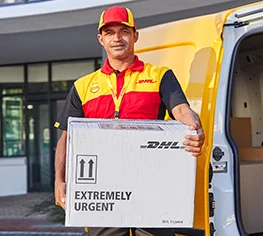 DHL Medical Express courier collecting the validated DHL Medical Box from a hospital with the DHL van in the background.